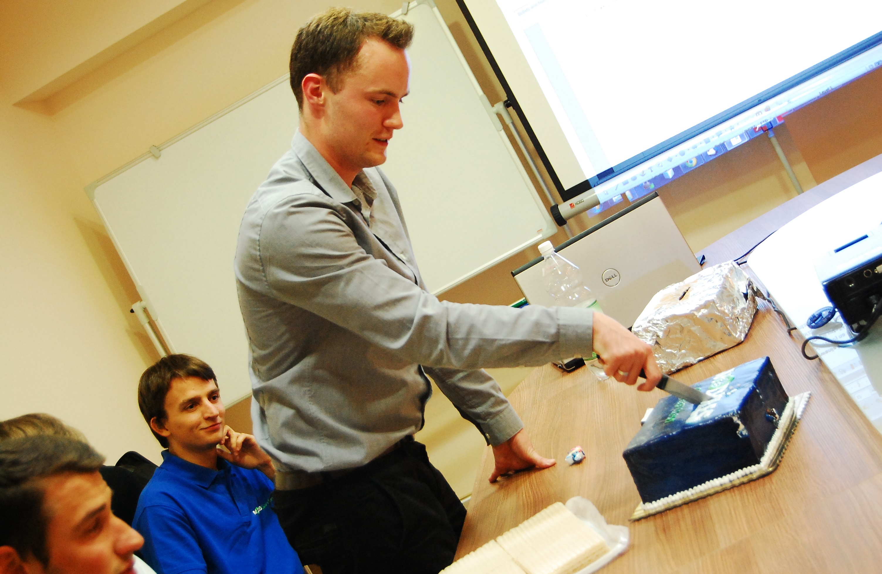 ModulesGarden CEO Konrad Keck Cutting A Cake